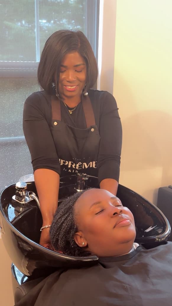 House of Glamor stylist shampooing a salon client